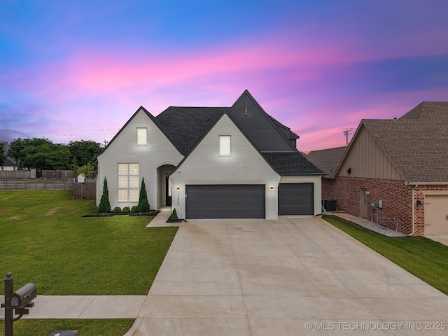 13859 S 21st Pl E, Bixby, OK 74008 - french country home with concrete driveway, a shingled roof, a garage, and brick siding