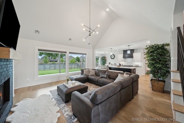 13859 S 21st Pl E, Bixby, OK 74008 - living room featuring a fireplace, high vaulted ceiling, a chandelier, light wood-style floors, and recessed lighting
