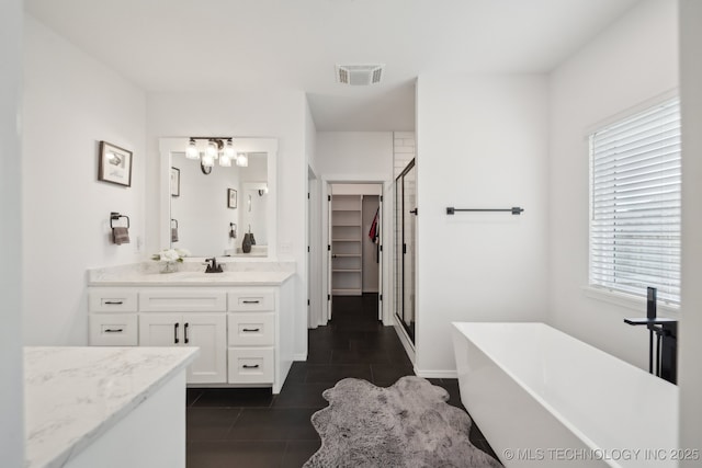 13859 S 21st Pl E, Bixby, OK 74008 - full bath featuring a stall shower, vanity, a soaking tub, tile patterned floors, and a chandelier