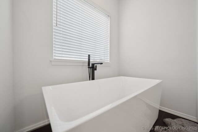 13859 S 21st Pl E, Bixby, OK 74008 - bathroom with a freestanding tub and baseboards