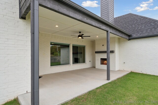 13859 S 21st Pl E, Bixby, OK 74008 - view of patio with a warm lit fireplace and ceiling fan