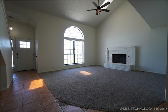8304 E 124th E Ave, Owasso, OK 74055 - unfurnished living room with a ceiling fan, tile patterned flooring, high vaulted ceiling, baseboards, and carpet floors