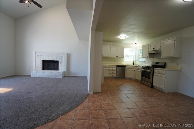 8304 E 124th E Ave, Owasso, OK 74055 - kitchen featuring appliances with stainless steel finishes, ceiling fan, under cabinet range hood, baseboards, and white cabinets