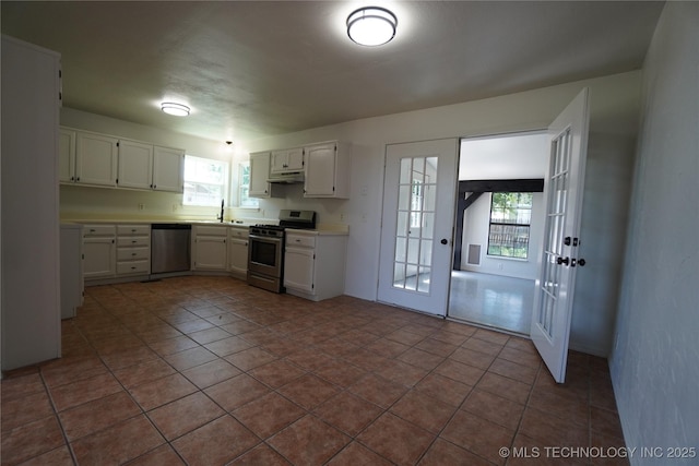 8304 E 124th E Ave, Owasso, OK 74055 - kitchen featuring appliances with stainless steel finishes, white cabinetry, light countertops, french doors, and under cabinet range hood