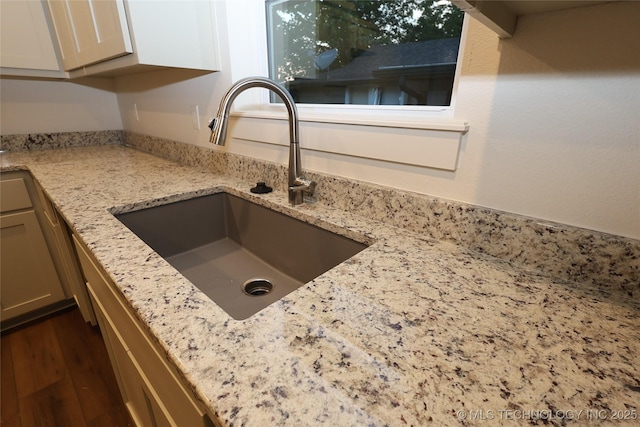 805 N Ridgeway St, Sapulpa, OK 74066 - kitchen view of a sink, light stone countertops, and dark wood finished floors