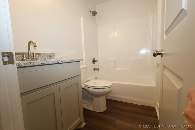 805 N Ridgeway St, Sapulpa, OK 74066 - bathroom with vanity, wood finished floors, and bathtub / shower combination
