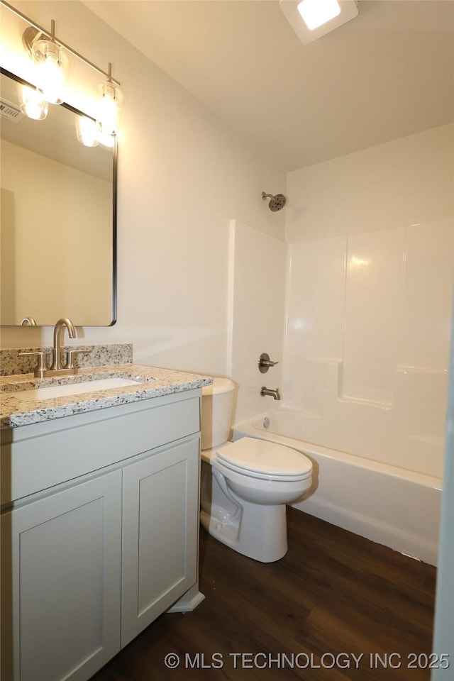 805 N Ridgeway St, Sapulpa, OK 74066 - bathroom featuring wood finished floors, vanity, and shower / washtub combination