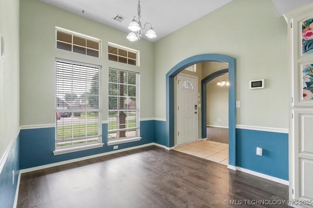 20001 E 46th St, Broken Arrow, OK 74014 - entrance foyer featuring a chandelier, arched walkways, wood finished floors, baseboards, and vaulted ceiling
