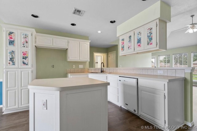 20001 E 46th St, Broken Arrow, OK 74014 - kitchen featuring dishwasher, dark wood-style floors, a peninsula, a sink, and recessed lighting