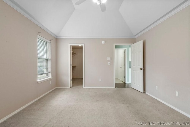 20001 E 46th St, Broken Arrow, OK 74014 - unfurnished bedroom with crown molding, lofted ceiling, a walk in closet, carpet flooring, and baseboards