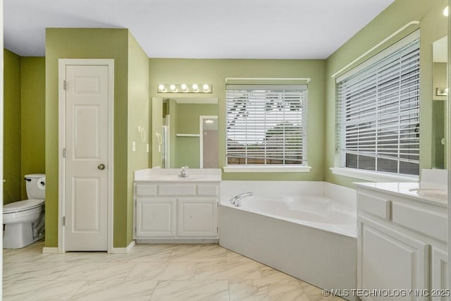 20001 E 46th St, Broken Arrow, OK 74014 - bathroom featuring a bath, two vanities, marble look tiles, and toilet