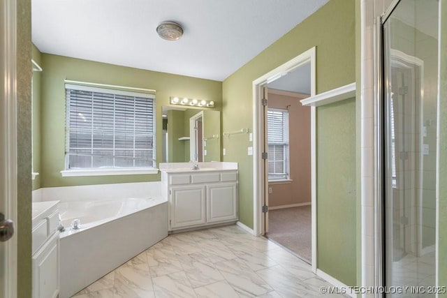20001 E 46th St, Broken Arrow, OK 74014 - bathroom with vanity, a garden tub, a shower stall, and marble look tile flooring