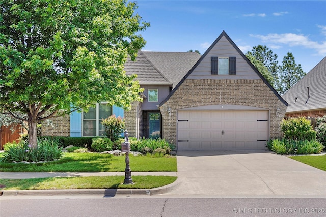 10935 S 77th Pl, Tulsa, OK 74133 - tudor house with brick siding, driveway, an attached garage, and roof with shingles