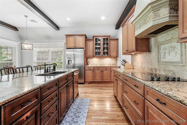 10935 S 77th Pl, Tulsa, OK 74133 - kitchen featuring a sink, stainless steel appliances, custom range hood, light wood-style flooring, and plenty of natural light