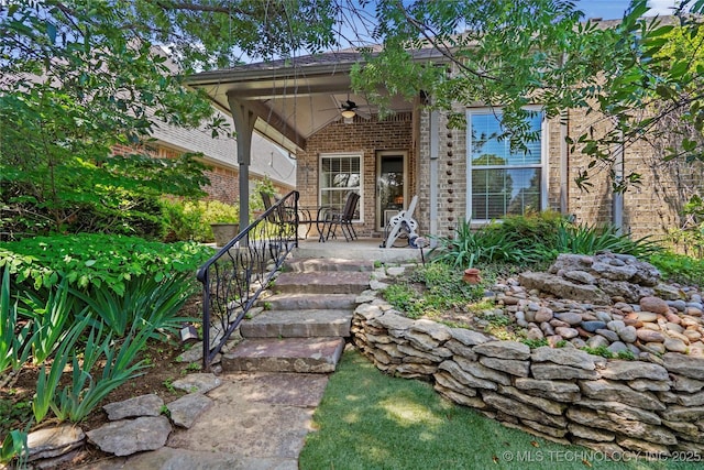 10935 S 77th Pl, Tulsa, OK 74133 - view of exterior entry featuring ceiling fan, brick siding, and a porch