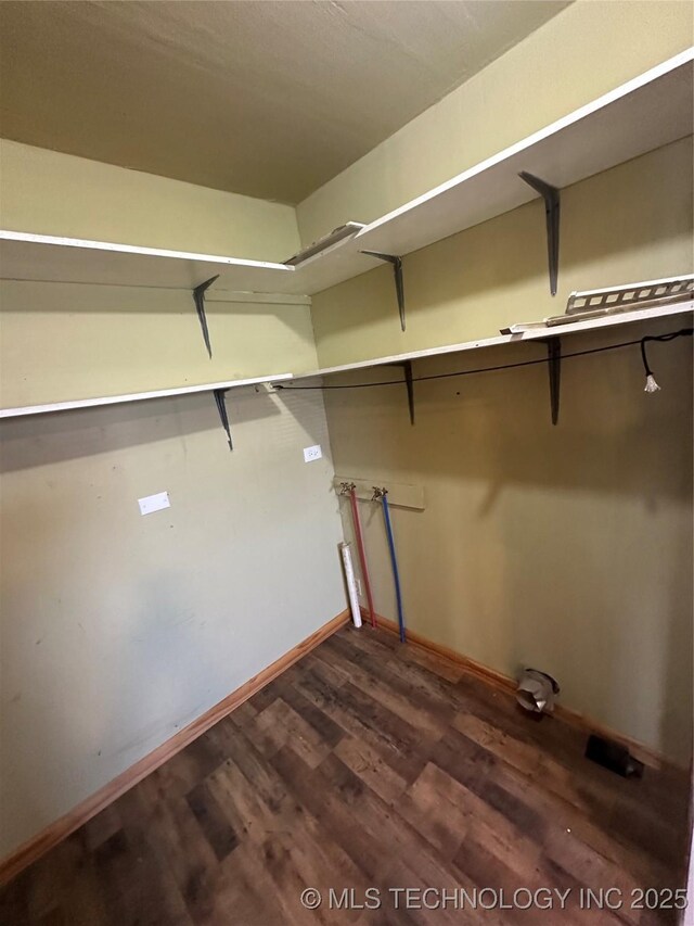 105 S B, Davis, OK 73030 - walk in closet featuring dark wood-style floors