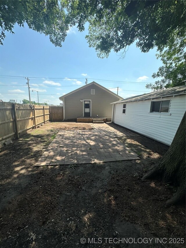 105 S B, Davis, OK 73030 - rear view of property with a fenced backyard and a patio