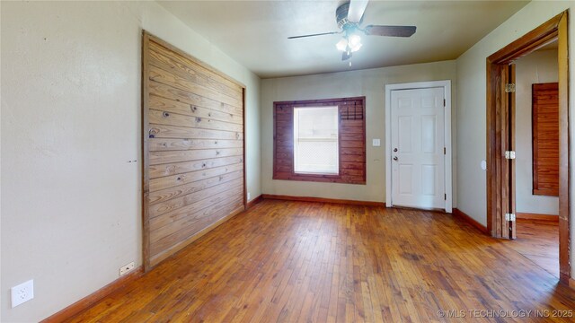 105 S B, Davis, OK 73030 - spare room featuring ceiling fan, hardwood / wood-style flooring, and baseboards