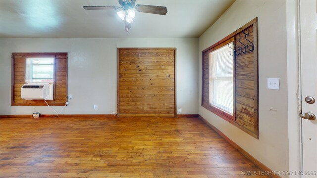 105 S B, Davis, OK 73030 - spare room featuring hardwood / wood-style flooring, cooling unit, healthy amount of natural light, and a ceiling fan
