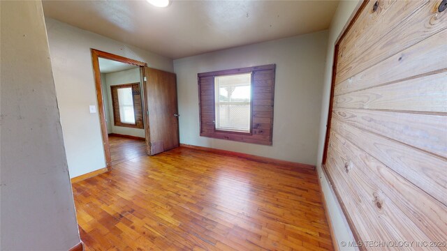 105 S B, Davis, OK 73030 - spare room with healthy amount of natural light, light wood-type flooring, and baseboards