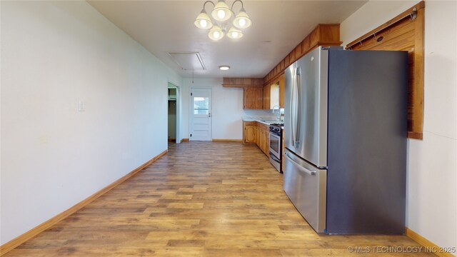 105 S B, Davis, OK 73030 - kitchen with appliances with stainless steel finishes, baseboards, light wood-style floors, and a sink