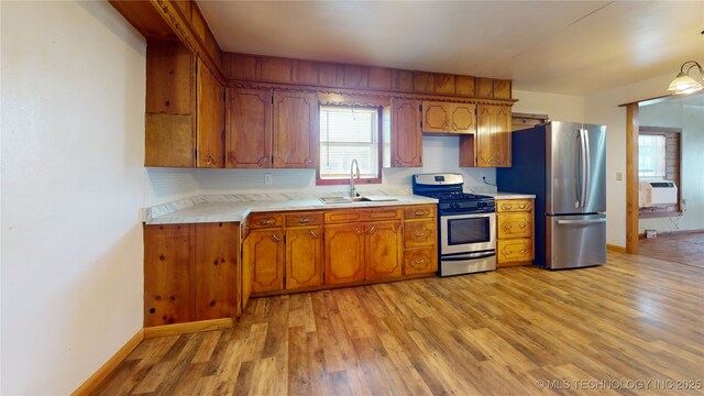 105 S B, Davis, OK 73030 - kitchen featuring stainless steel appliances, a sink, light countertops, light wood-style flooring, and brown cabinetry