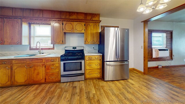 105 S B, Davis, OK 73030 - kitchen with stainless steel appliances, light countertops, cooling unit, a sink, and light wood-type flooring