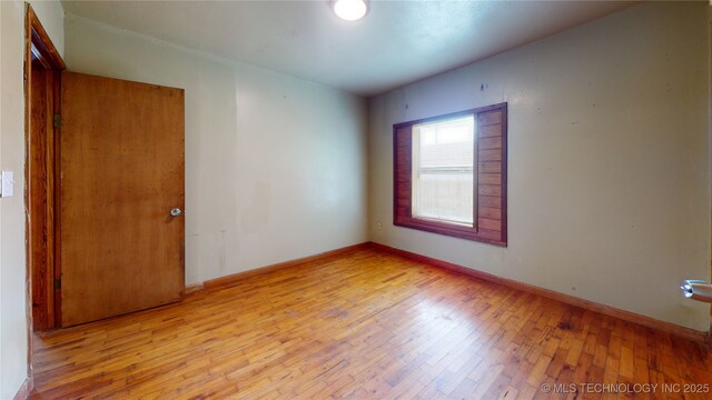 105 S B, Davis, OK 73030 - empty room featuring hardwood / wood-style floors and baseboards