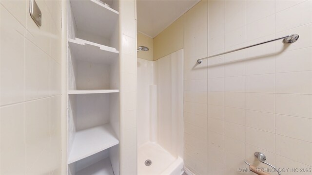 105 S B, Davis, OK 73030 - bathroom with a stall shower and tile walls