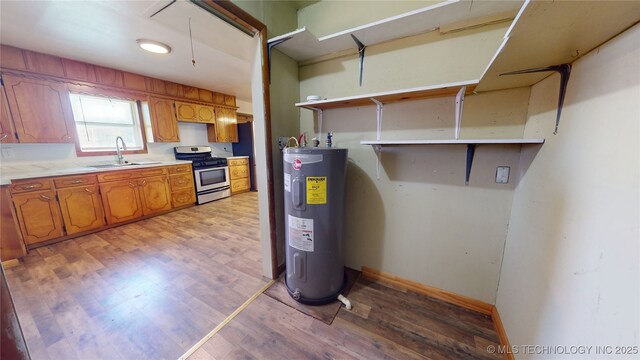 105 S B, Davis, OK 73030 - utility room featuring electric water heater and a sink