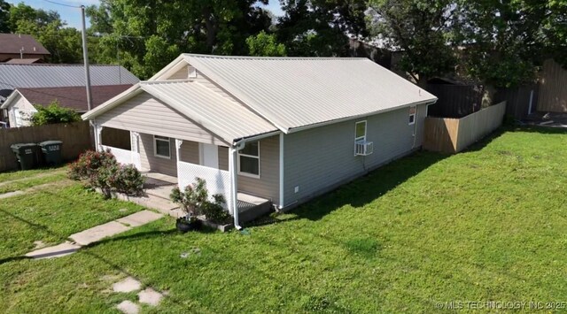 105 S B, Davis, OK 73030 - view of front of house with metal roof, cooling unit, and a patio area