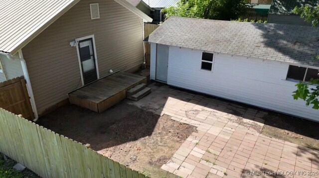 105 S B, Davis, OK 73030 - back of property featuring a fenced backyard, a patio, a deck, and a shingled roof