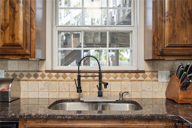 1608 Blue Stem Rd, Fort Gibson, OK 74434 - kitchen with a sink, dark stone countertops, decorative backsplash, and healthy amount of natural light