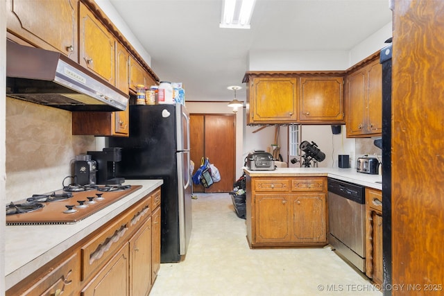 709 N Maple, Konawa, OK 74849 - kitchen with stainless steel appliances, under cabinet range hood, and brown cabinets