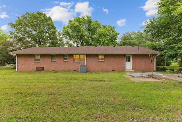 709 N Maple, Konawa, OK 74849 - back of house with central AC unit, crawl space, a lawn, and brick siding