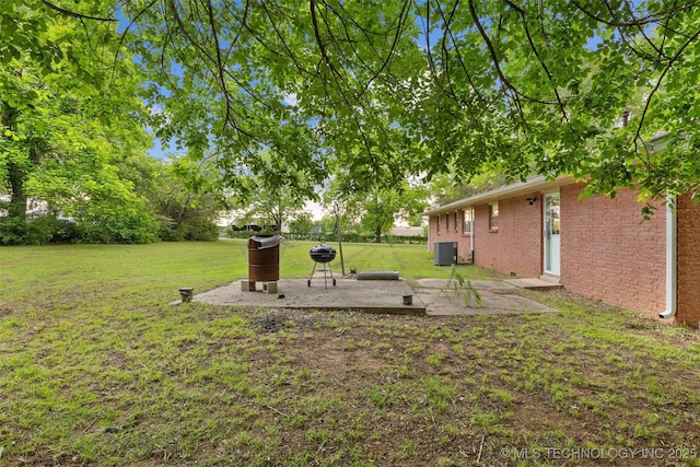 709 N Maple, Konawa, OK 74849 - view of grassy yard with central AC and a patio area