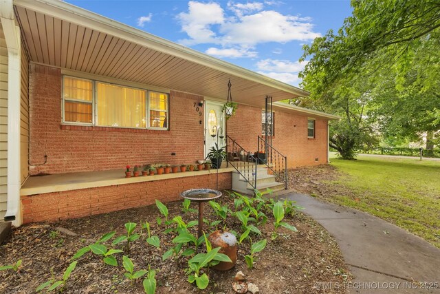 709 N Maple, Konawa, OK 74849 - view of front of house with brick siding and a front lawn