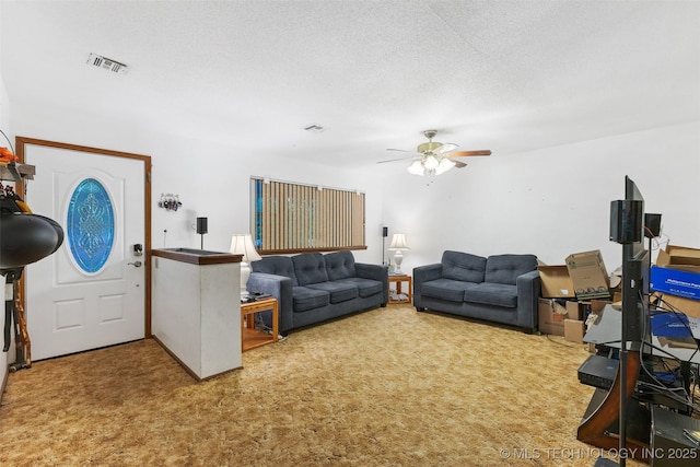 709 N Maple, Konawa, OK 74849 - living area featuring ceiling fan, carpet, and a textured ceiling