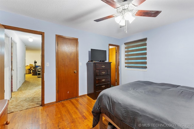 709 N Maple, Konawa, OK 74849 - bedroom with light wood finished floors, baseboards, and a ceiling fan