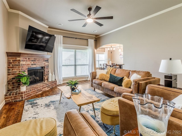 5909 E 139th St, Collinsville, OK 74021 - living area with wood finished floors, ceiling fan, ornamental molding, a brick fireplace, and baseboards