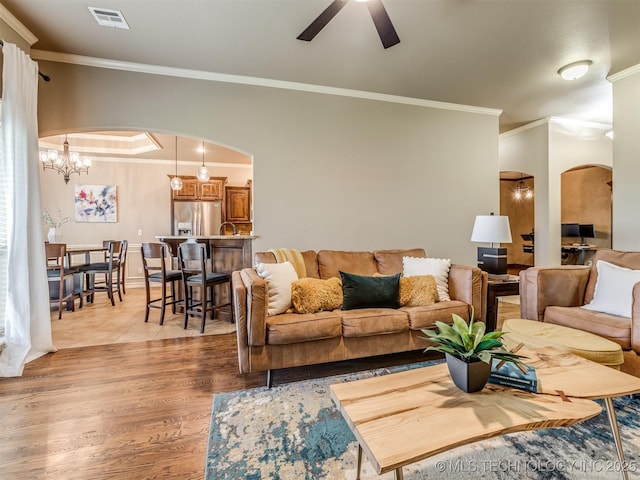 5909 E 139th St, Collinsville, OK 74021 - living area with arched walkways, ornamental molding, light wood finished floors, and ceiling fan