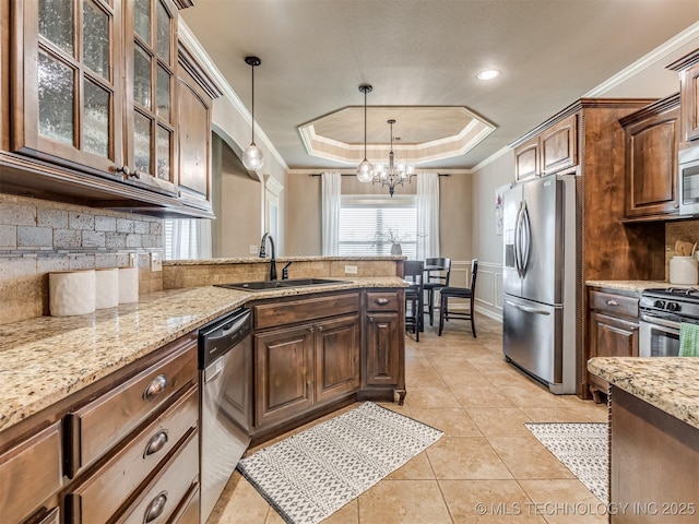 5909 E 139th St, Collinsville, OK 74021 - kitchen featuring appliances with stainless steel finishes, a sink, a raised ceiling, a chandelier, and crown molding