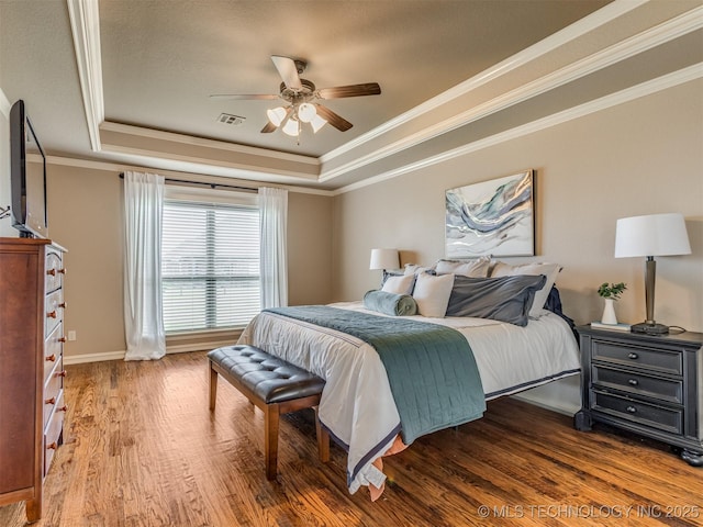 5909 E 139th St, Collinsville, OK 74021 - bedroom featuring a tray ceiling, crown molding, wood finished floors, baseboards, and ceiling fan