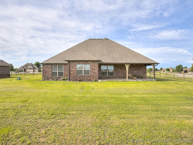 5909 E 139th St, Collinsville, OK 74021 - back of house with a patio, roof with shingles, and brick siding