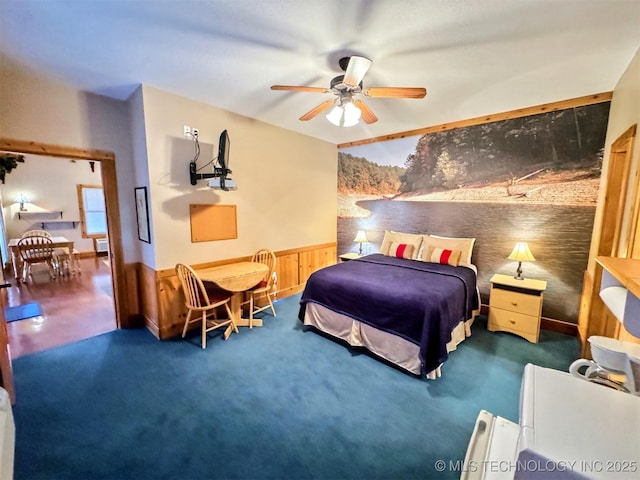 20965 W 921st Rd, Cookson, OK 74427 - bedroom featuring wainscoting, carpet floors, a ceiling fan, and wood walls
