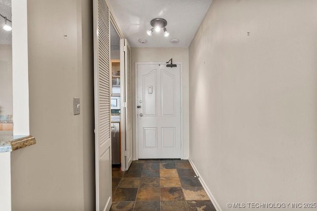 1502 S Boulder Ave Unit 16Cd, Tulsa, OK 74119 - doorway to outside with stone finish floors and baseboards