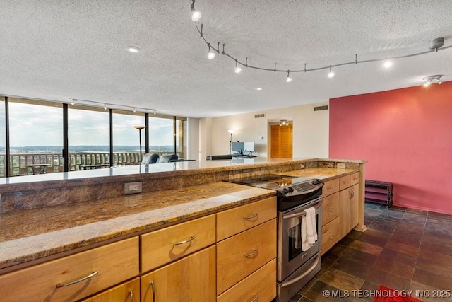 1502 S Boulder Ave Unit 16Cd, Tulsa, OK 74119 - kitchen featuring stainless steel electric range oven, a textured ceiling, light stone countertops, and dark stone finish floors