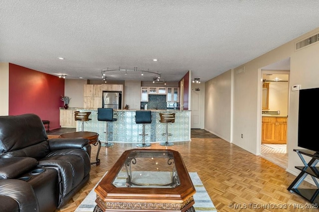 1502 S Boulder Ave Unit 16Cd, Tulsa, OK 74119 - living room featuring a textured ceiling and baseboards