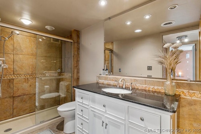 1502 S Boulder Ave Unit 16Cd, Tulsa, OK 74119 - bathroom with vanity, toilet, a shower stall, and recessed lighting