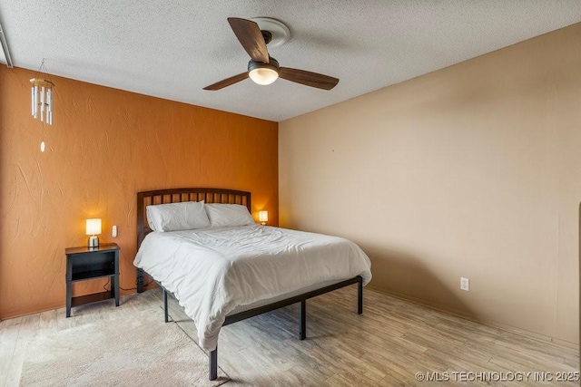 1502 S Boulder Ave Unit 16Cd, Tulsa, OK 74119 - bedroom featuring a textured ceiling, wood finished floors, and a ceiling fan